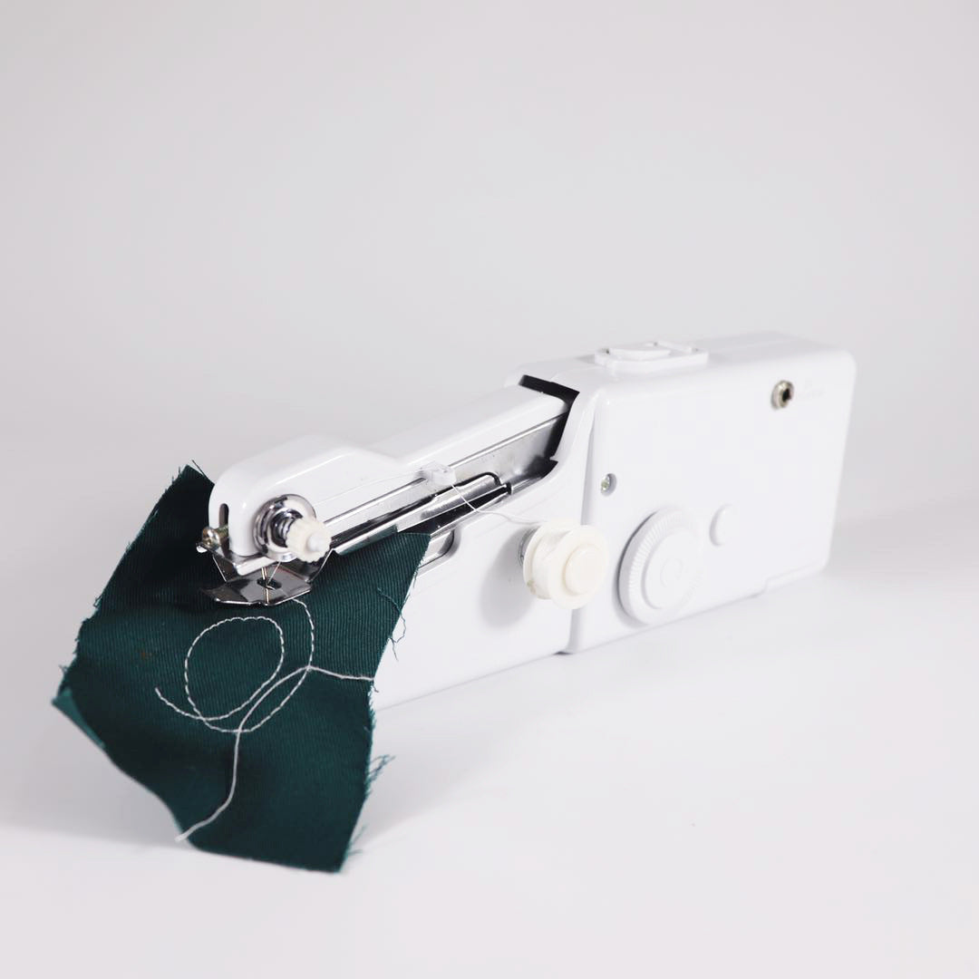 Hand-held portable sewing machine